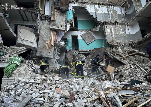 In this photo provided by the Ukrainian Emergency Services on Nov. 19, 2024, rescue workers clear the rubble of a residential building destroyed by a Russian strike in Hlukhiv, Ukraine. 