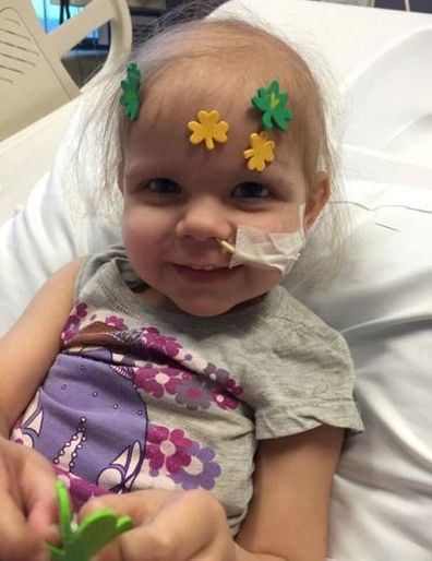 Young girl in a hospital bed.