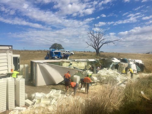 The semi-trailer rolled six metres down an embankment and landed upside down in a paddock. (Picture: Toby Vue/ Yass Tribute)