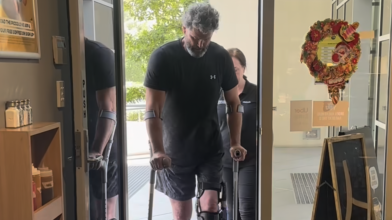 Chris Cairns walks into a pub on crutches and sporting leg braces, two years after a heart attack and a subsequent spinal cord injury.
