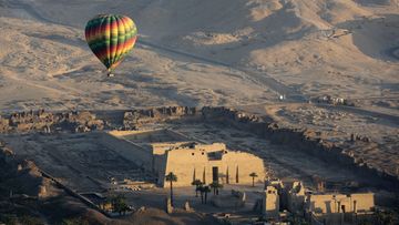 A hot air balloon flies over the temple of Ramsis III at Medinet Habu on the west bank of the Nile River in Luxor, Egypt, in 2016. (Associated Press)