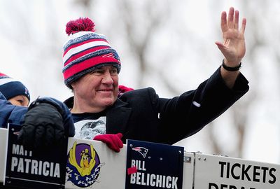Coach Bill Belichick waves to the supporters.
