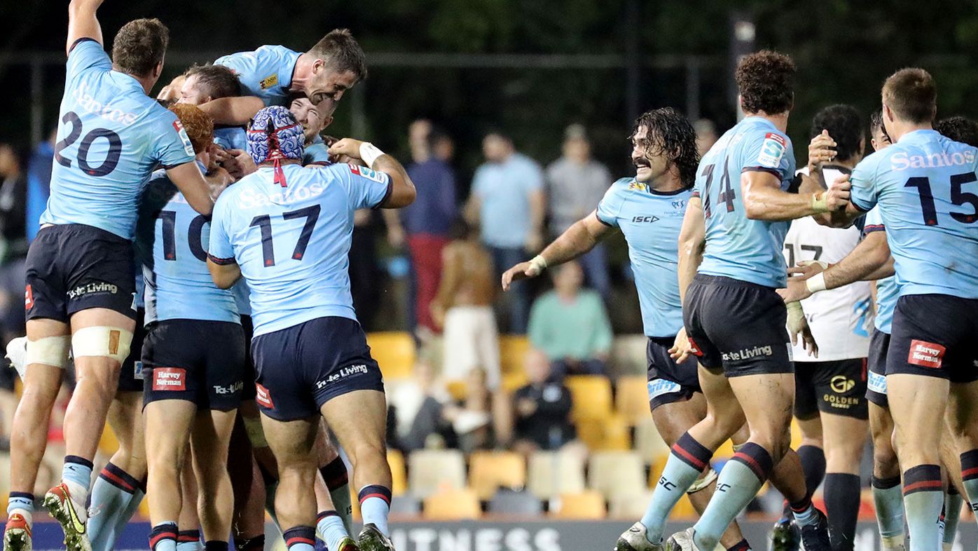 Waratahs players celebrate defeating the Crusaders at full time.