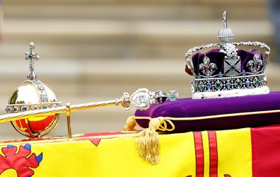 The Sovereign's Orb, Sceptre and The Imperial State Crown sit on top of Queen Elizabeth II's Royal Standard draped coffin