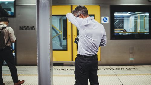 A commuter at Town Hall station wipes away sweat on the muggiest day on record in Sydney.