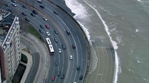 The high waves can be seen crashing onto what appears to be a motorway. (ABC-7 Chicago)