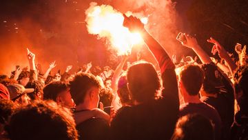 04/12/22 Soccer fans throw flares as they prepare to watch Australia take on Argentina in their knockout game in the 2022 World Cup, Federation Square, Melbourne. Photograph by Chris Hopkins