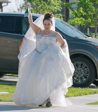 Jaime Sladek from Georgetown, Texas pose in their wedding dresses for fun social distancing photoshoot by neighbour Elyssa Seibel