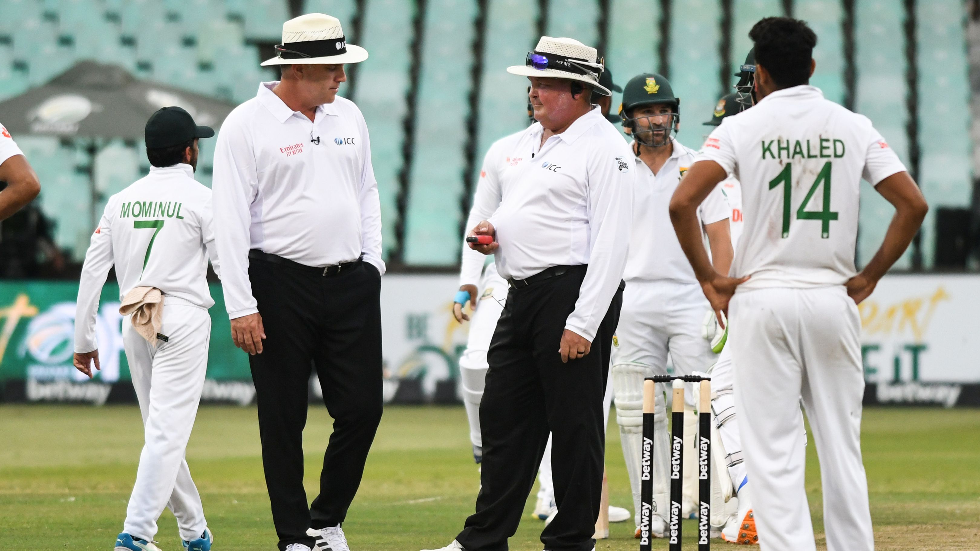 The South African umpires convene amongst themselves ahead of the resumption of play.