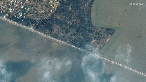 This satellite image provided by Maxar Technologies on Friday, March 18, 2022 shows a line of cars leaving Mariupol, Ukraine. 