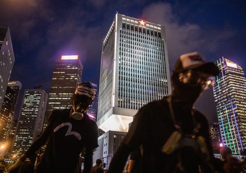 Protesters walk in front of the People's Liberation Army Barracks after a school boycott rally in Central district on September 2, 2019 in Hong Kong. Pro-democracy protesters have continued demonstrations across Hong Kong since 9 June against a controversial bill which allows extraditions to mainland China.
