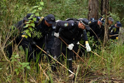 The police are using rakes and shovels to comb through every inch of the bushland. Picture: AAP
