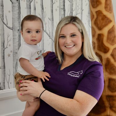 Anna Baker cuddles up to a cute baby.