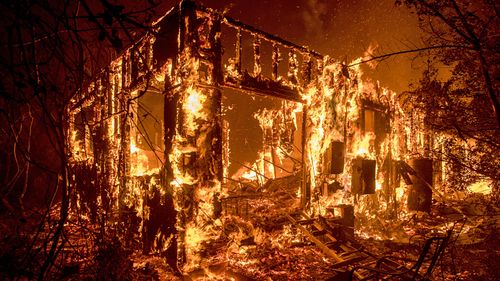 Flames consume a home in Ojah, California. (Photo: AP).