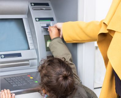 Mother and daughter at ATM