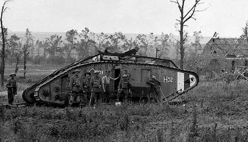 Australian soldiers with one of the British tanks that fought at Hamel. (Photo: AWM).