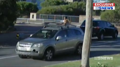 A Perth child has been seen, wearing just a nappy, sitting upright on the roof racks of a moving car.
