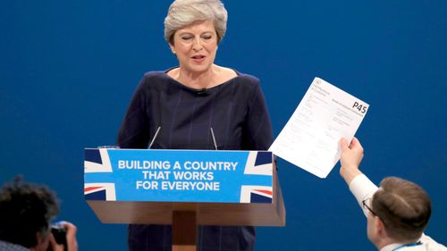 Comedian Simon Brodkin, also known as Lee Nelson, confronts British Prime Minister Theresa May during her keynote speech at the Conservative Party Conference in Manchester. (AAP)