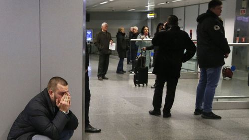 A relative of one of flight stewardesses, who were on the board a Ukrainian 737-800 plane that crashed on the outskirts of Tehran, Iran, reacts at Borispil international airport.