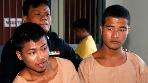 Myanmar migrant workers, who are accused of the killing of two British tourists, Zaw Lin (R) and Wai Phyo (L) are escorted by a Thai police officer after they were sentenced to death