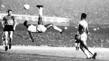 FILE - In this Sept. 1968 file photo, Brazil&#x27;s Pele kicks the ball during a friendly soccer game against Belgium in Rio de Janeiro, Brazil. On Oct. 23, 2020, the three-time World Cup winner Pelé turns 80 without a proper celebration amid the COVID-19 pandemic as he quarantines in his mansion in the beachfront city of Guarujá, where he has lived since the start of the pandemic.  (AP Photo, File)