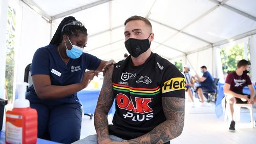 Panthers fan Shane Binns receives the Pfizer COVID-19 vaccine at a pop-up clinic. 