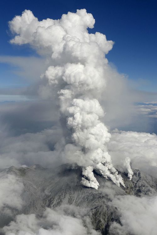 Photo taken from a Kyodo News airplane shows columns of smoke rising from Mt. Ontake. (AAP)