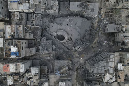 The rubble of a mosque, destroyed in an Israeli airstrike, is seen at Shati refugee camp in Gaza City early Monday, Oct. 9, 2023. Israel's military battled to drive Hamas fighters out of southern towns and seal its borders Monday as it pounded the Gaza Strip.