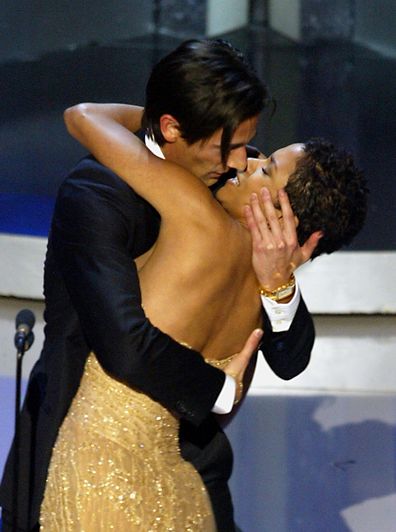 Adrien Brody surprises presenter Halle Berry with a kiss after he won the Oscar in 2003