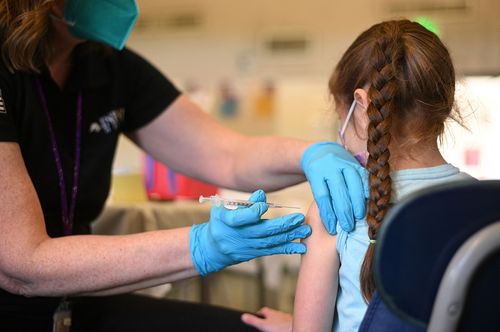 A nurse administers a pediatric dose of the Covid-19 vaccine to a girl at a L.A. Care Health Plan vaccination clinic at Los Angeles Mission College in the Sylmar neighborhood in Los Angeles, California, January 19, 2022 