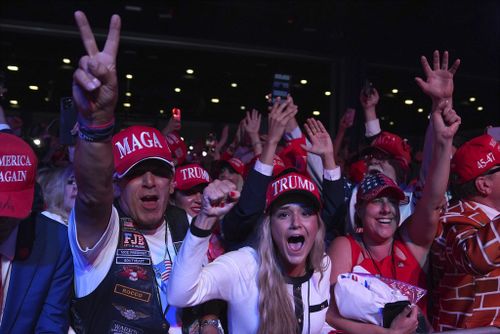 Supporters watch returns at an election night party for Republican presidential candidate former President Donald Trump at the Palm Beach Convention Center, Wednesday, Nov. 6, 2024, in West Palm Beach, Fla. (AP Photo/Evan Vucci)