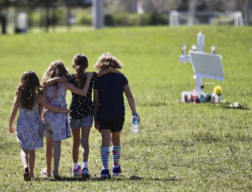 Children approach a vigil post in Parkland. (AAP)