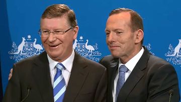 Premier Napthine and Prime Minister Abbott awkwardly embraced at a joint press conference in Melbourne. (9NEWS)