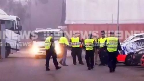 Uniformed police inspected 40 trucks in Minchinbury at dawn. Picture: 9NEWS