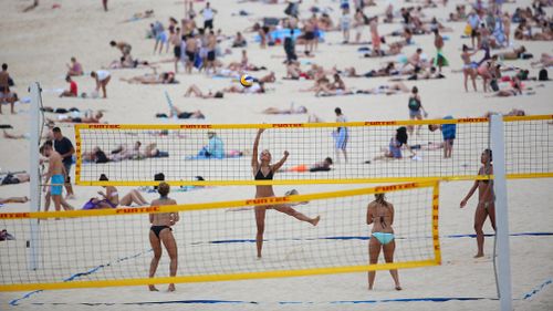 Volleyball players enjoy an Aussie beach. (AAP)