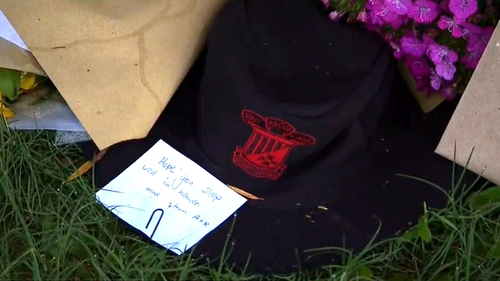 A tribute of flowers and notes is growing outside the house where Max Chirila died.