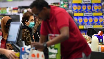 People shopping are seen in Woolworths supermarket in Coburg, Melbourne, Thursday, March 19, 2020. 