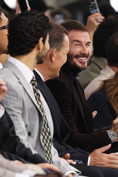 MILAN, ITALY - SEPTEMBER 24: (L to R) Ishaan Khattar, HUGO BOSS CEO Daniel Grieder, David Beckham sit in the Boss front row during Milan Fashion Week Womenswear Spring/Summer 2026 on September 25, 2025 in Milan, Italy. (Photo by Jed Cullen/Dave Benett/Getty Images)
