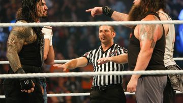 Roman Reigns and Bray Wyatt stare each other down at the WWE SummerSlam 2015.