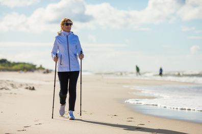 Nordic walking - people training on the beach