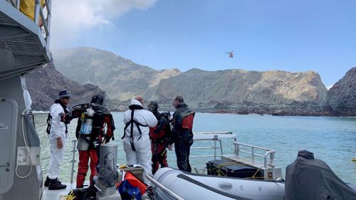 Police divers prepare to search the waters near White Island off the coast of Whakatane, New Zealand, Saturday Dec. 14, 2019. A team of nine from the Police National Dive Squad resumed their search at early Saturday for a body seen in the water following Monday's volcanic eruption