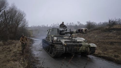 A Ukrainian self-propelled artillery changes position after shooting towards Russian forces at a frontline in Kharkiv region, Ukraine, Saturday, Dec. 24, 2022. (AP Photo/Evgeniy Maloletka)