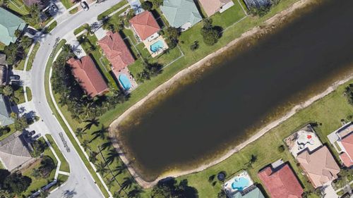 This Google Earth image showed a submerged car in a Florida retention pond.