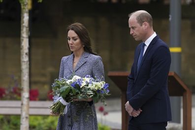 Catherine, Duchess Of Cambridge lays flowers as she and her husband Prince William, Duke of Cambridge attend the launch of the Glade of Light Memorial garden, outside Manchester Cathedral on May 10, 2022 in Manchester, England.  
