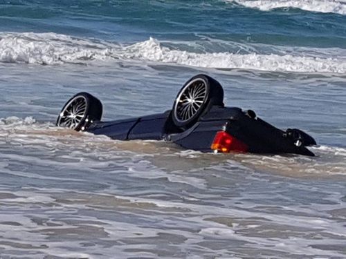 The movement of the waves and the wet sand slowly submerged the vehicle. (Queensland Ambulance Service)