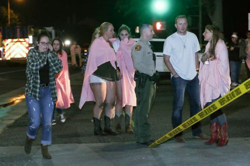 People who managed to escape the bar shooting were seen gathering outside the venue as police arrived.