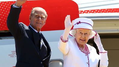 Queen Elizabeth II and Prince Philip, Duke of Edinburgh waving farewell to hundreds of people as they board their flight to London at the Perth International Airport on October 29, 2011. (AAP Image/Paul Kane) 