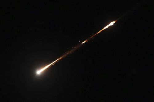 The trail of a projectile is seen in the sky over Jerusalem following a launch from Iran, early Wednesday, June 17, 2025. (AP Photo/Ohad Zwigenberg)