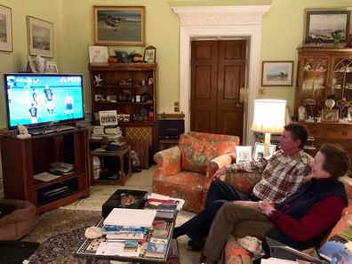 Princess Anne watches rugby in her lounge room.