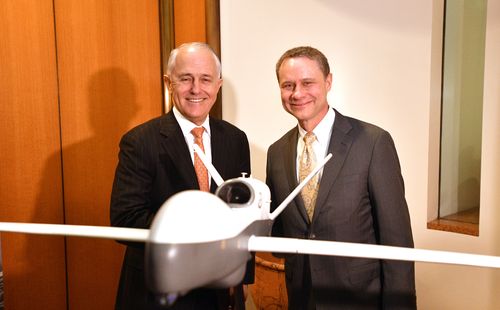 Turnbull and Northrop Grumman CEO Wes Bush with a replica of a MQ-4C Triton drone at Parliament House today. Picture: AAP
